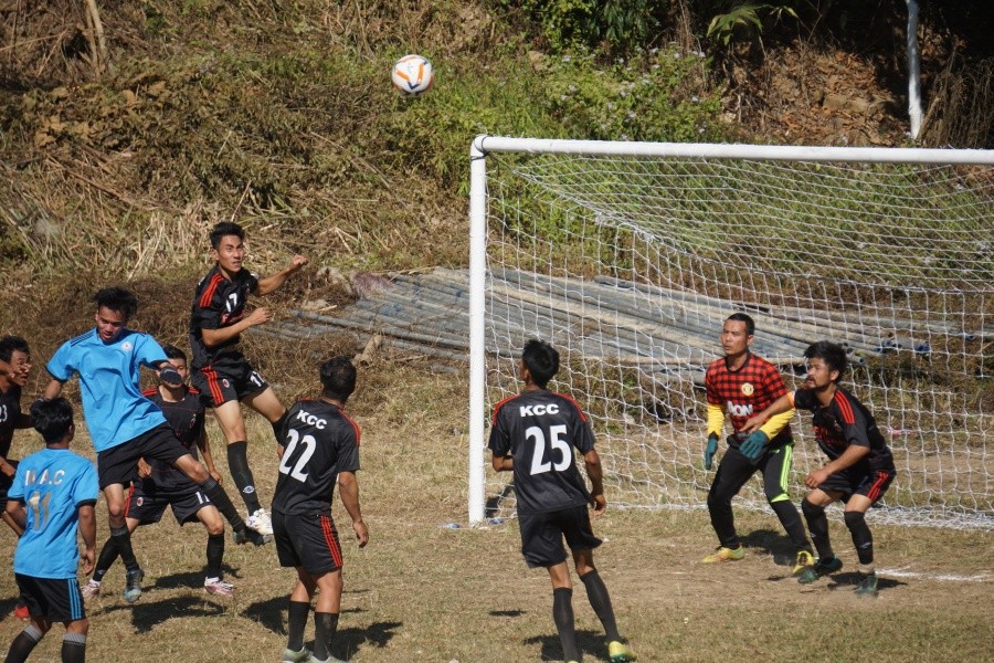 Players of MongsenAit Club (blue jersey) head the ball against Khanimu Citizen Club (black) during the day one of the MongsenAit Marok, in Longjang, Mokokchung on Monday.